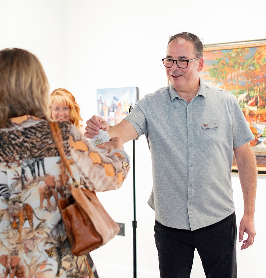 Volunteer greeting guests at Spiva Arts Center