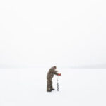 Photo of a man ice fishing