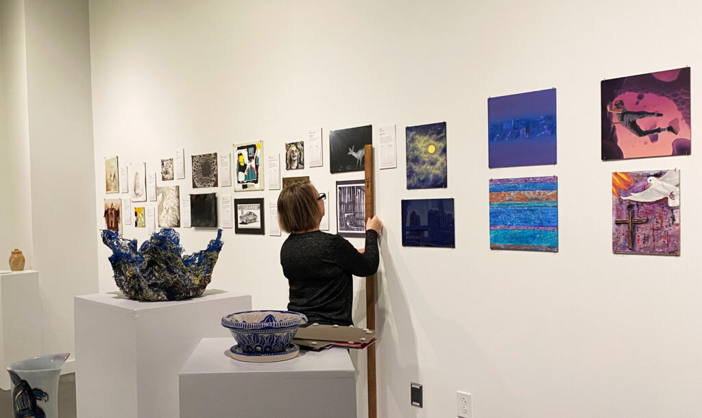 Volunteers adding to gallery at Spiva