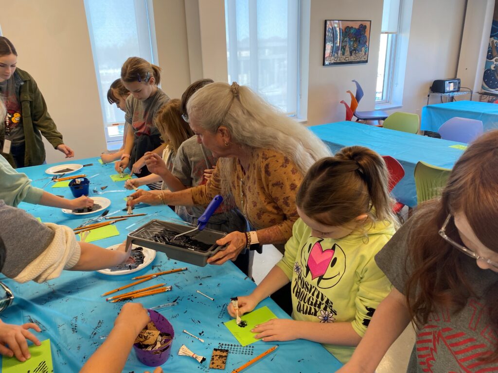 Volunteer working with kids during 3rd grade visits